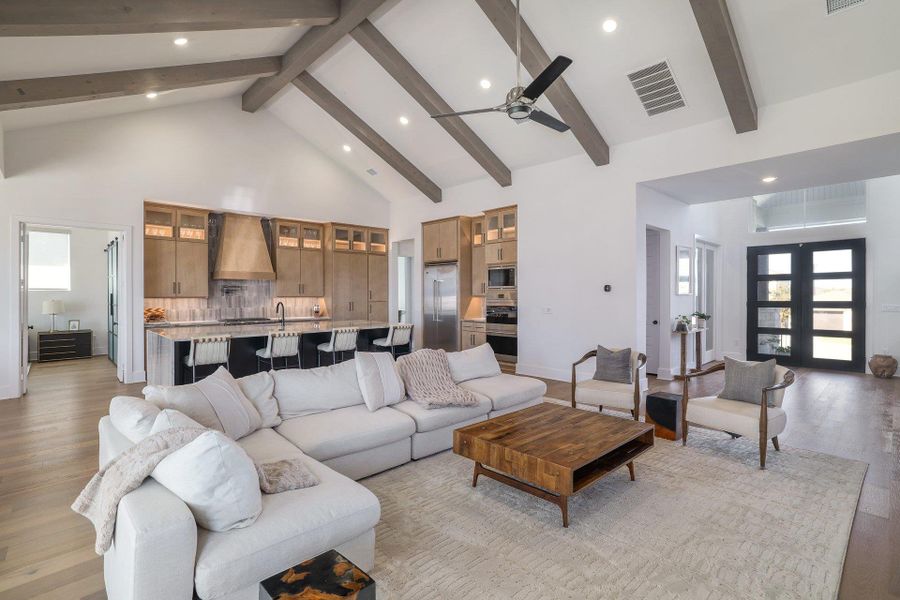 An additional view showcases the open flow between living spaces, anchored by refined finishes and abundant natural light.