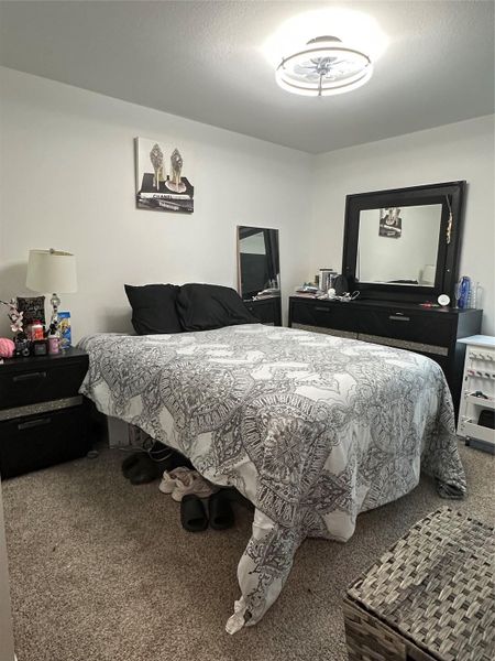 Carpeted bedroom featuring a textured ceiling