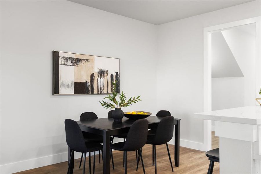 Dining room featuring light wood-style flooring and baseboards