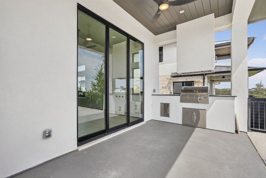 Exterior details and patio area of a home in Milky Way at River Place, Austin (Image 21).