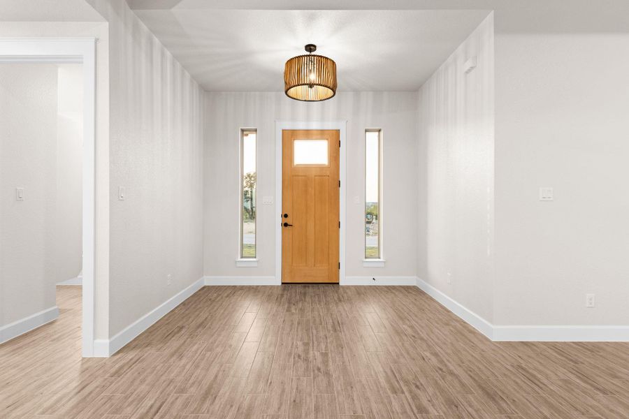 Foyer featuring wood finished floors and baseboards Foyer featuring wood finished floors and baseboards