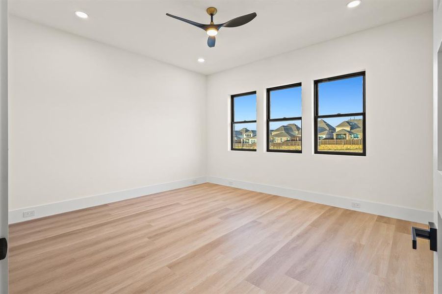 Unfurnished room with light hardwood / wood-style flooring and ceiling fan