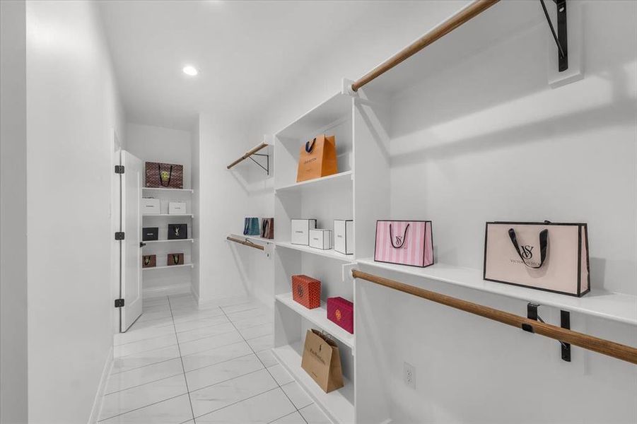 Spacious closet featuring light tile patterned flooring