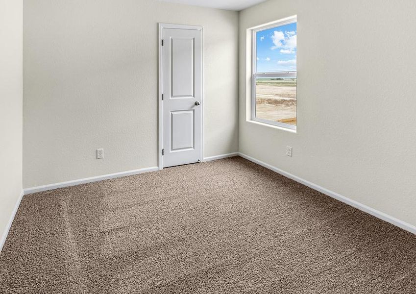 Guest bedroom with a window and a walk-in closet.