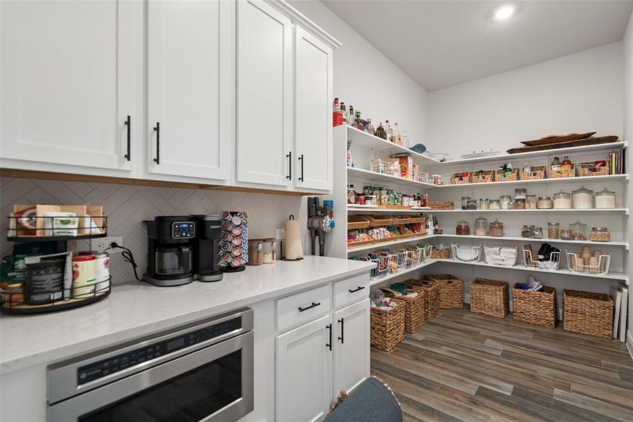 A dedicated pantry space offers extensive shelving for optimal organization. A dedicated pantry space offers extensive shelving for optimal organization.
