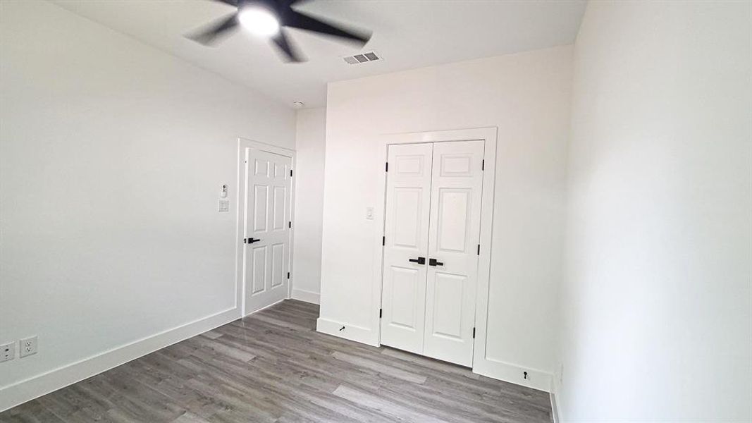 Room with ceiling fan light wood-style high-end vinyl floors