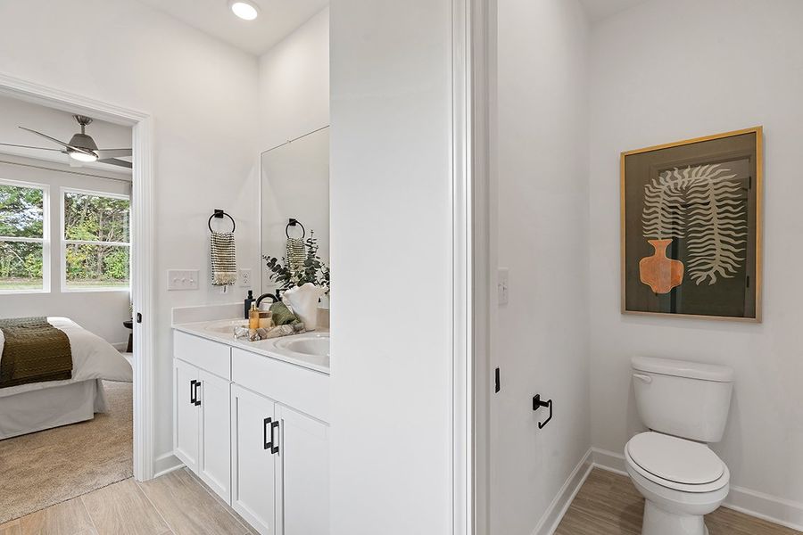 A bathroom with a toilet and sink. A bathroom with a toilet and sink.