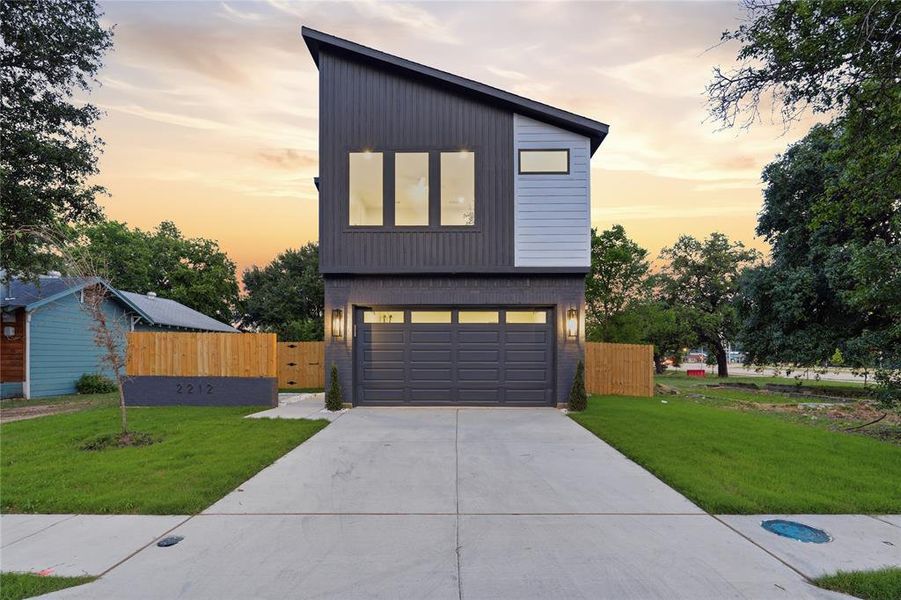 Contemporary architecture featuring a distinctive angular roofline, dark vertical siding, and light gray horizontal siding accents Contemporary architecture featuring a distinctive angular roofline, dark vertical siding, and light gray horizontal siding accents