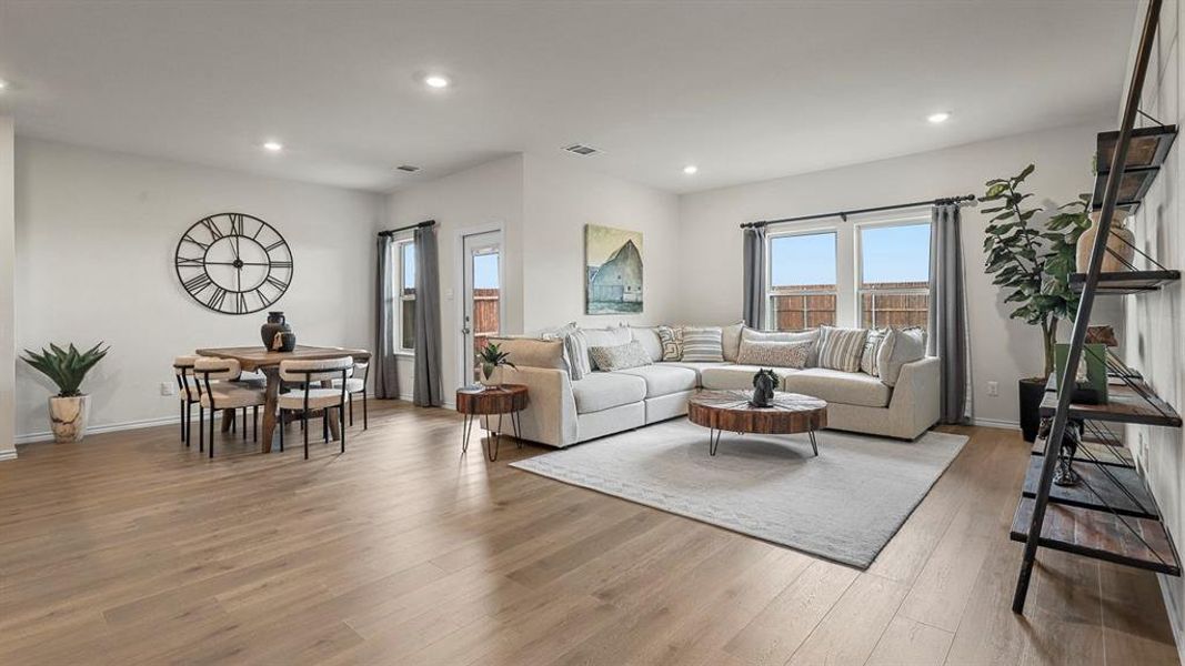 Living room with recessed lighting and hardwood / wood-style flooring