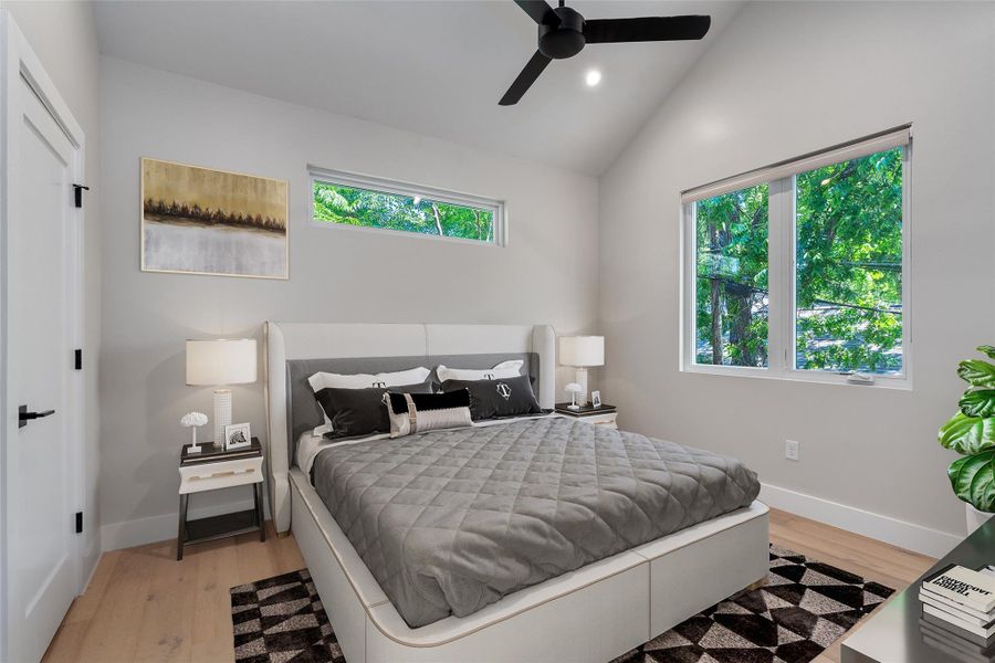 Virtually Staged. Primary Bedroom, bright and airy. Vaulted ceilings enhance this space, featuring large windows, clerestory windows, and light wood-finish flooring Virtually Staged. Primary Bedroom, bright and airy. Vaulted ceilings enhance this space, featuring large windows, clerestory windows, and light wood-finish flooring