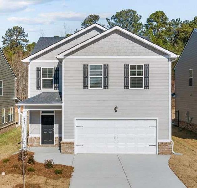 Front exterior of a new home in Poplar Preserve, Newnan, GA, highlighting curb appeal (Image 1).