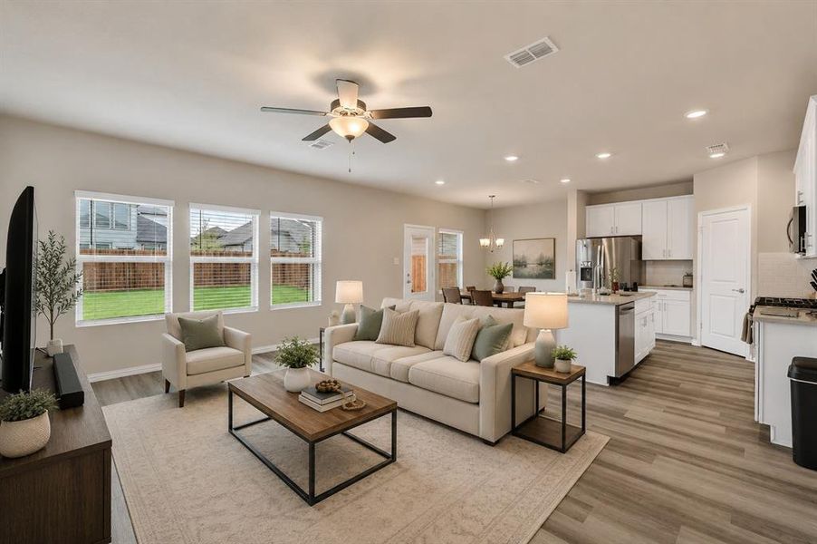 *Virtual Staged* Open-concept living area featuring wood-finish flooring, recessed lighting, and a ceiling fan