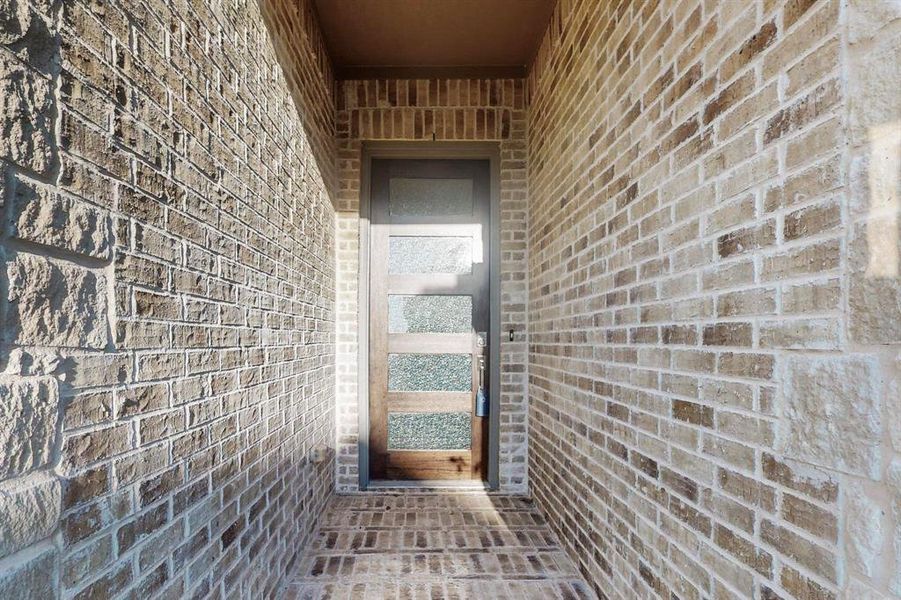 Entrance to property with brick siding