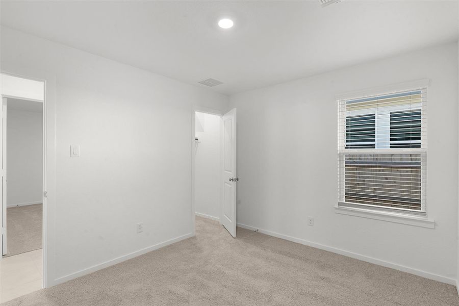 Empty room with light carpet and baseboards