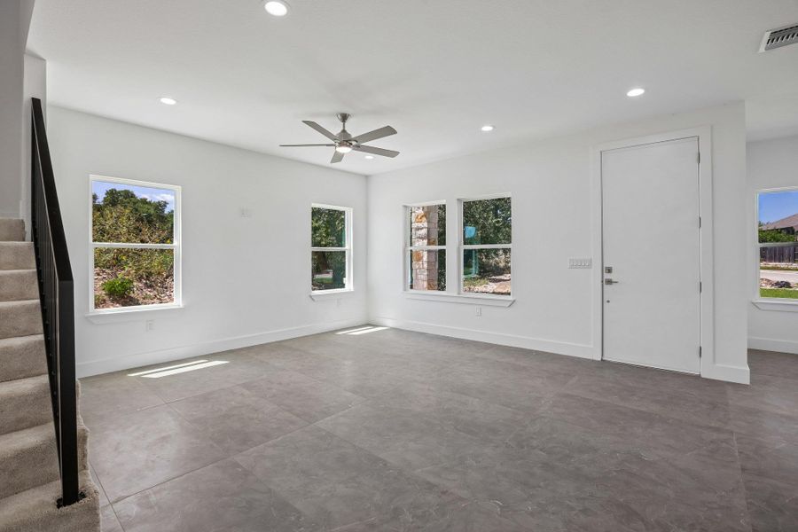 Gleaming tile floors and clean white walls establish a modern tone throughout the main living space.