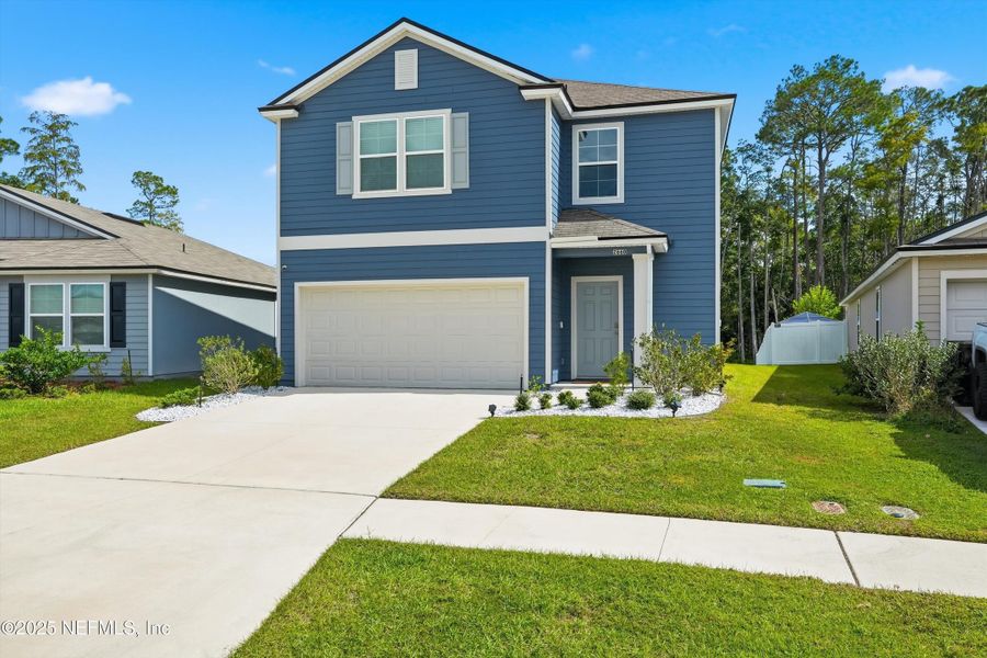 Front exterior of a new home in Cross Creek Express, Green Cove Springs, FL, highlighting curb appeal (Image 2). Front exterior of a new home in Cross Creek Express, Green Cove Springs, FL, highlighting curb appeal (Image 2).