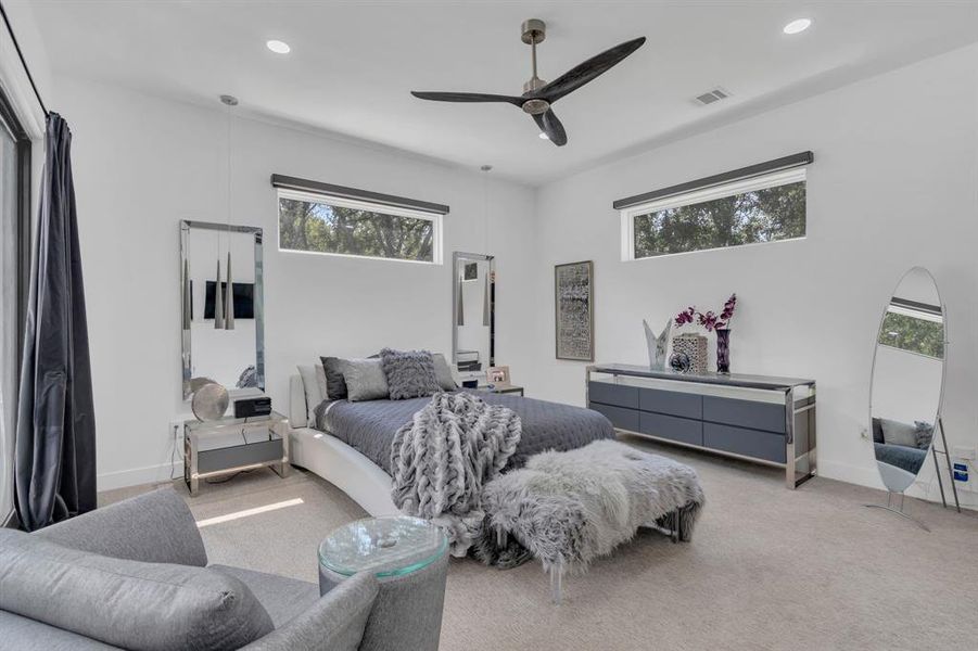Bedroom featuring multiple windows, carpet, ceiling fan, and recessed lighting