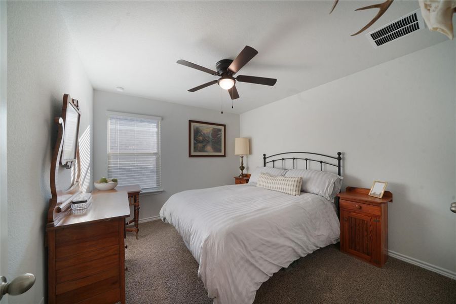 Bedroom featuring carpet floors and ceiling fan