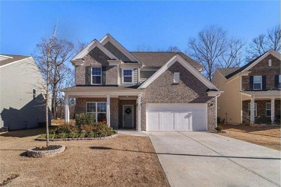 Front exterior of a new home in Pinebrook at Hamilton Mill, Auburn, GA, highlighting curb appeal (Image 23). Front exterior of a new home in Pinebrook at Hamilton Mill, Auburn, GA, highlighting curb appeal (Image 23).