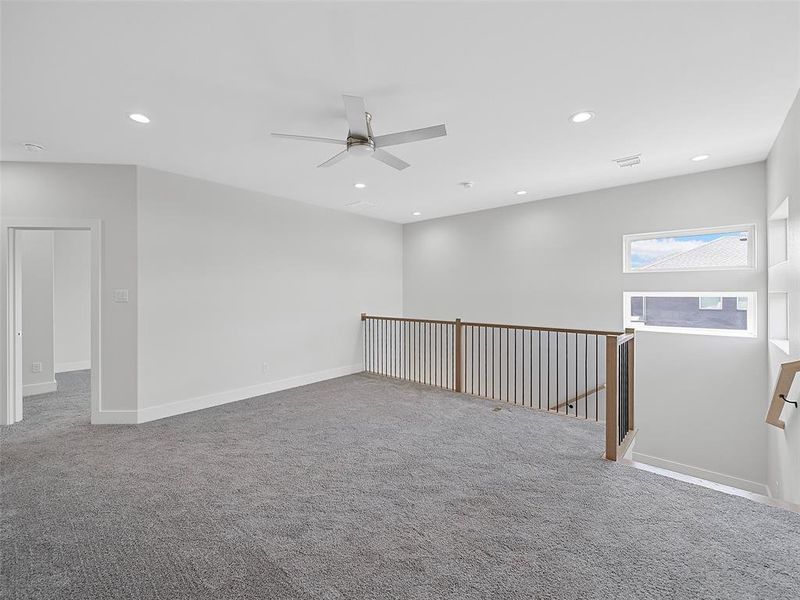 Carpeted game room featuring ceiling fan