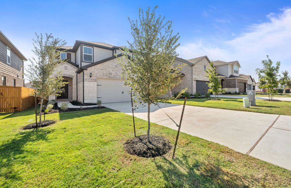 Front exterior of a new home in Crosswinds, Kyle, TX, highlighting curb appeal (Image 21).