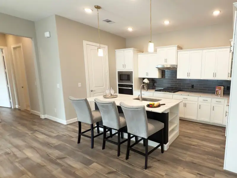 The heart of the home, this beautifully appointed kitchen blends style and function with expansive prep space, elegant finishes, and an open design perfect for gathering. Image depicts home as-is.