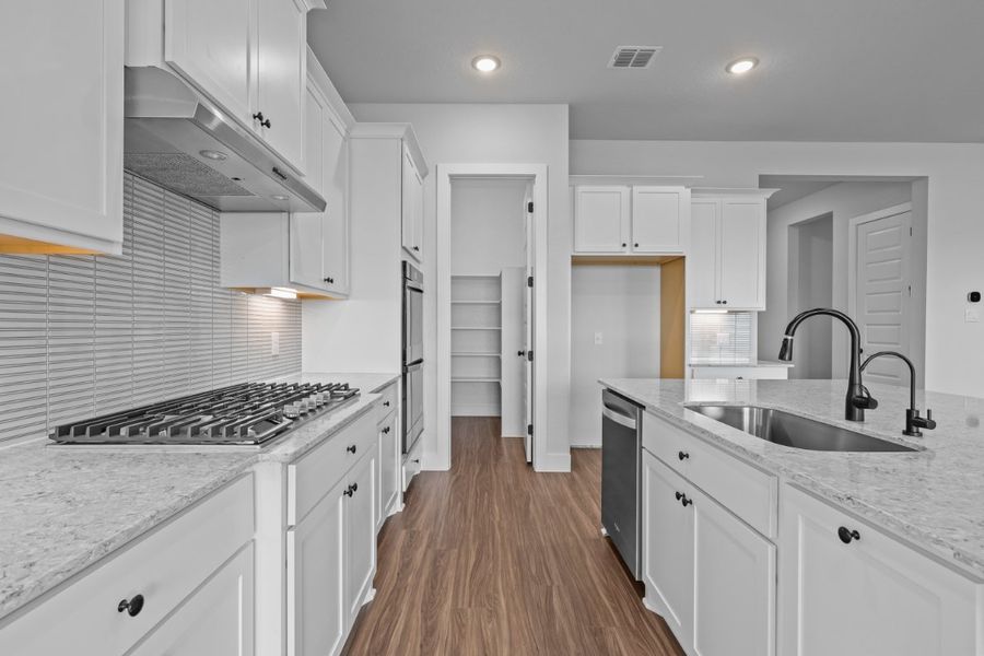 A kitchen with white cabinets. A kitchen with white cabinets.