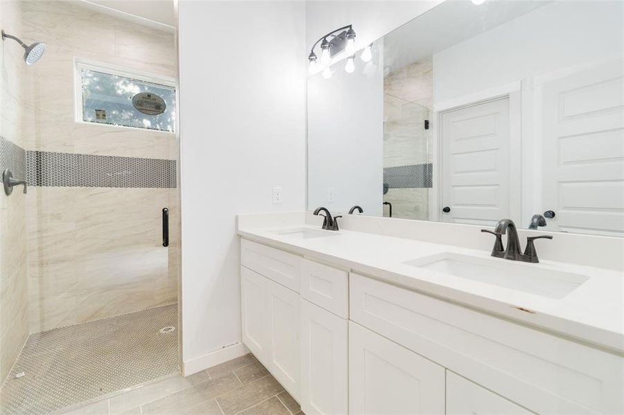 Primary ensuite with double vanity and walk-in shower