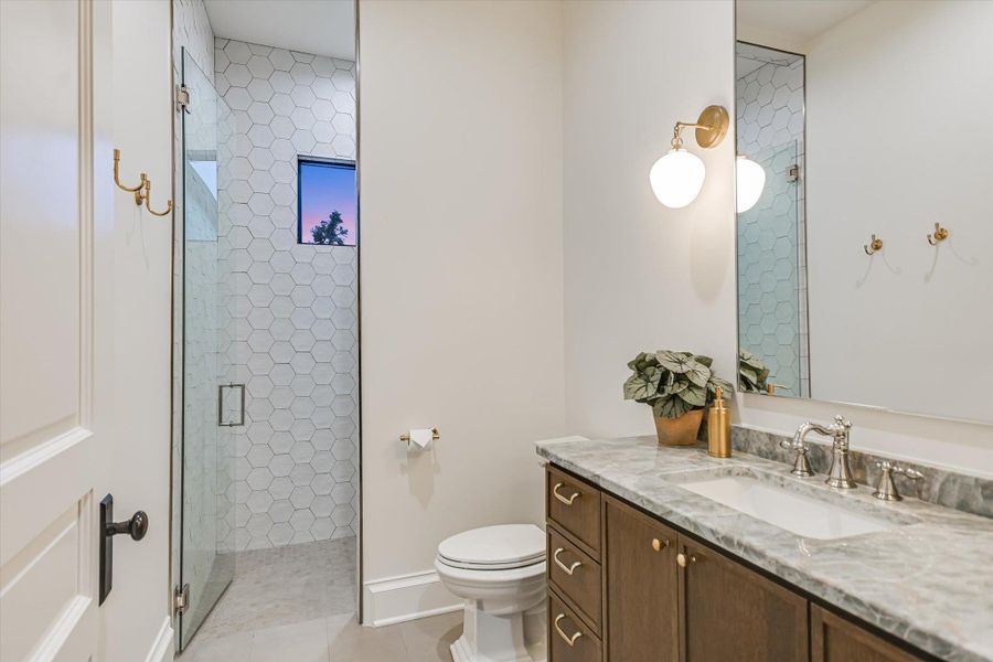 Full bath with a shower stall, vanity, and light tile patterned floors Full bath with a shower stall, vanity, and light tile patterned floors