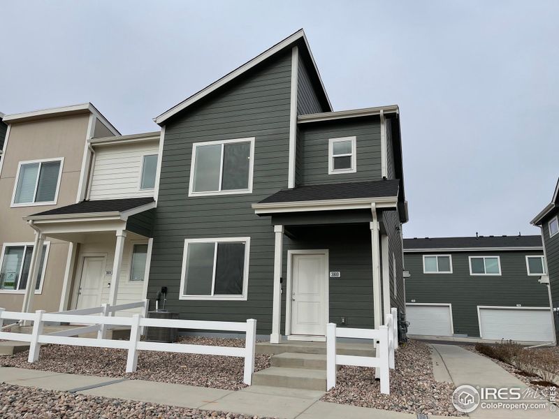 Front exterior of a new home in Liberty Draw, Evans, CO, highlighting curb appeal (Image 1).