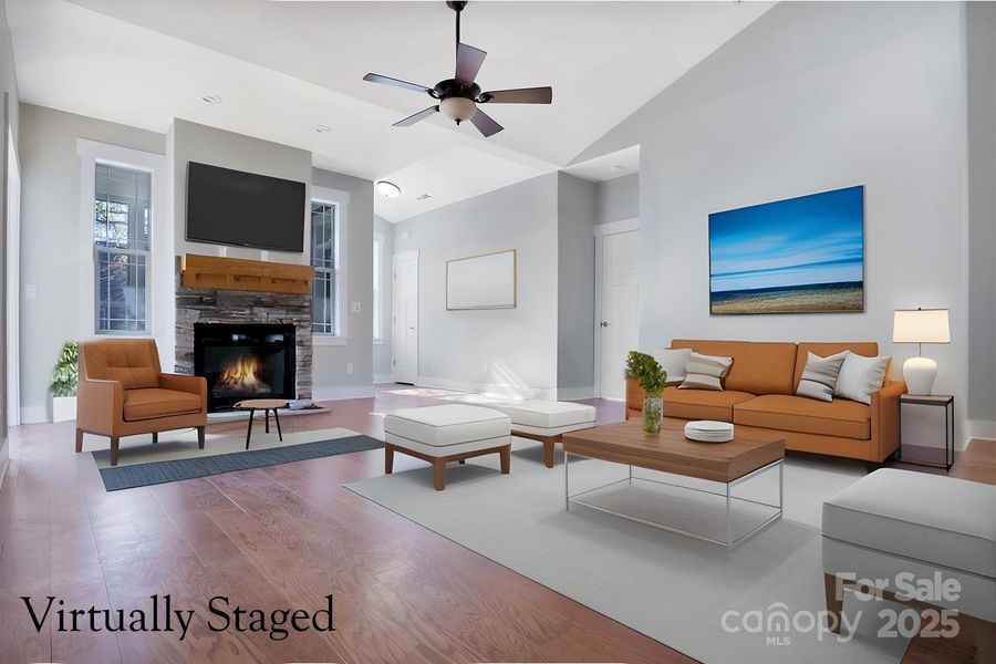 Open living space with fireplace and dramatic ceilings Open living space with fireplace and dramatic ceilings