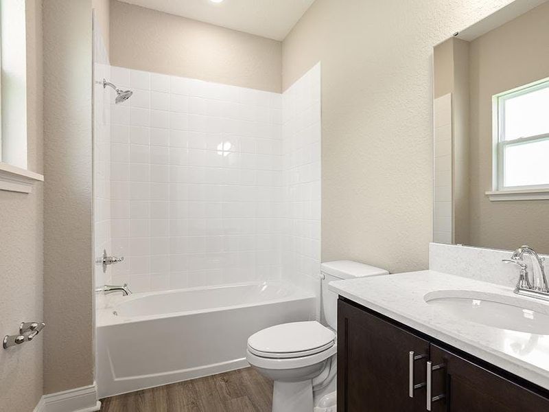 The en-suite bath for bedroom 2 includes a tub, or optional tiled shower - Monroe 55+ by Highland Homes