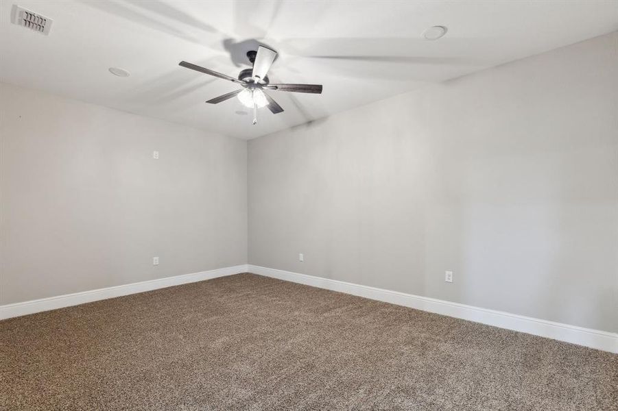 Room with carpet floors, baseboards, and ceiling fan Room with carpet floors, baseboards, and ceiling fan