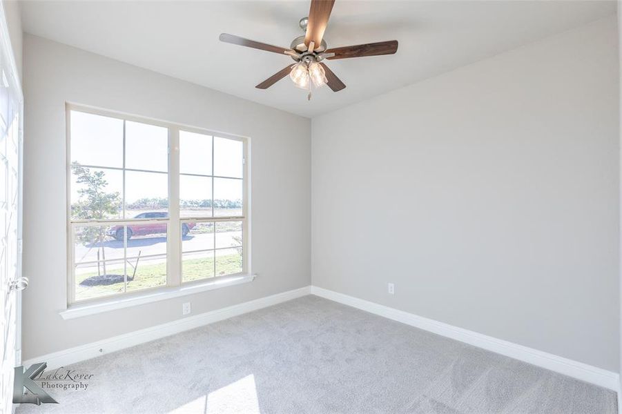Unfurnished room with carpet and ceiling fan