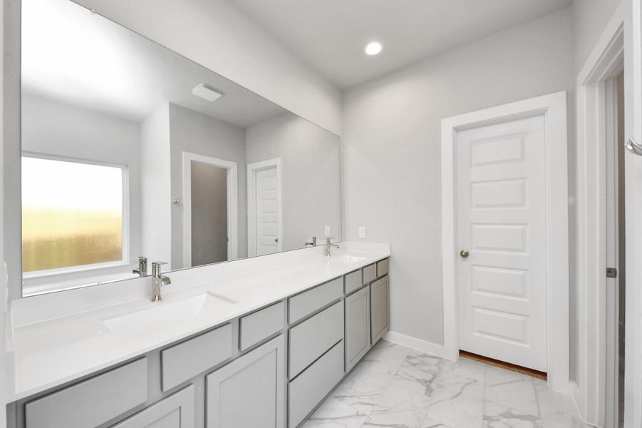 Escape to a spa-like oasis in this primary bathroom. Enjoy a walk-in shower with tile surround, a separate garden tub with custom detailing, and an elegant vanity featuring light countertops, modern hardware, and beautiful recessed lights. Experience luxury and relaxation in every detail. Escape to a spa-like oasis in this primary bathroom. Enjoy a walk-in shower with tile surround, a separate garden tub with custom detailing, and an elegant vanity featuring light countertops, modern hardware, and beautiful recessed lights. Experience luxury and relaxation in every detail.