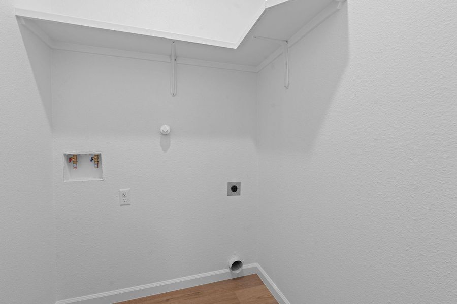 Laundry room featuring washer hookup, wood finished floors, and hookup for an electric dryer