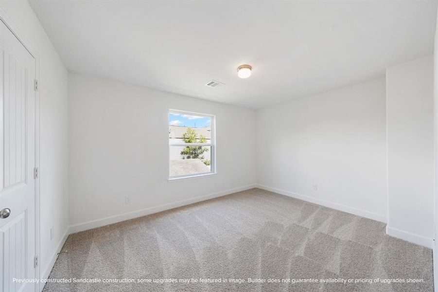 Perfectly sized, this secondary bedroom features a walk-in closet with custom shelving for maximum organization.