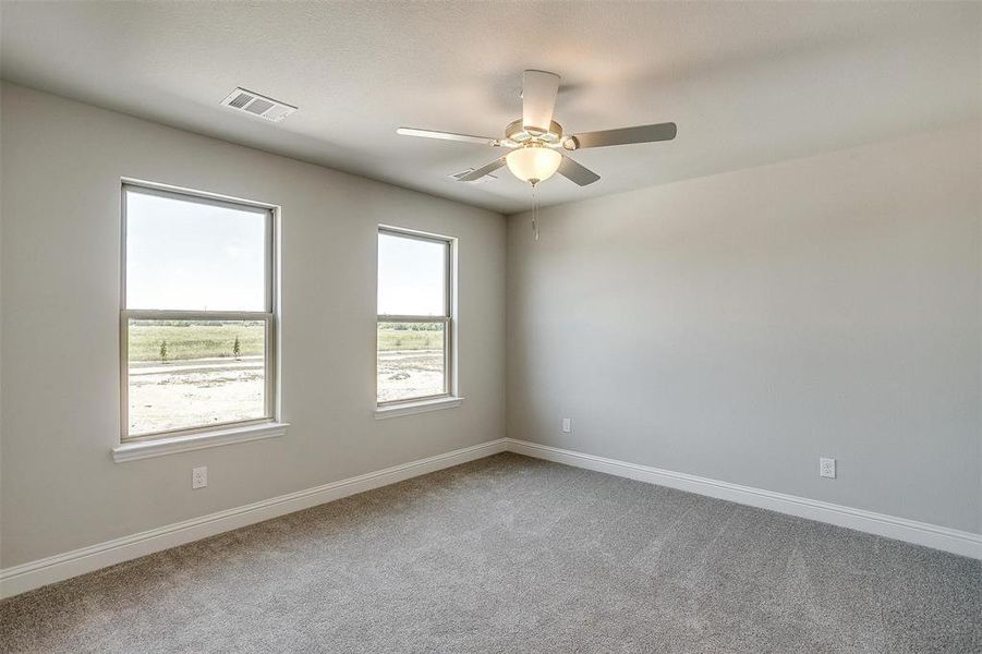 Spare room with light carpet and ceiling fan