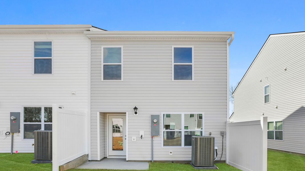 Exterior details and patio area of a home in Tanglewood Townes, Greenville (Image 3).