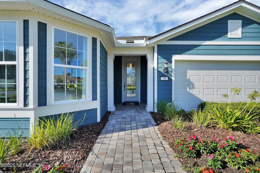 Front exterior of a new home in Summer Bay at Grand Oaks, St. Augustine, FL, highlighting curb appeal (Image 22). Front exterior of a new home in Summer Bay at Grand Oaks, St. Augustine, FL, highlighting curb appeal (Image 22).