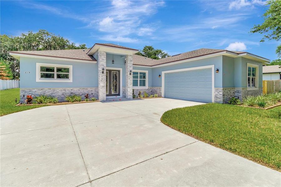 Front exterior of a new home in , Leesburg, FL, highlighting curb appeal (Image 24).