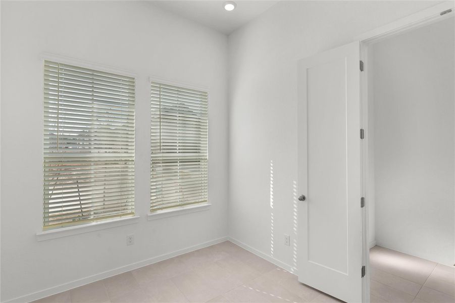 Unfurnished room with light tile patterned floors