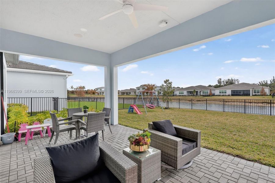 Experience effortless indoor-outdoor living in your southwest-facing backyard, where stunning sunsets set the scene. A fully automated electric patio screen and integrated surround sound system make entertaining or relaxing a breeze, while the fenced yard, customizable GoBee exterior lighting, and lake views create the ultimate Florida lifestyle.