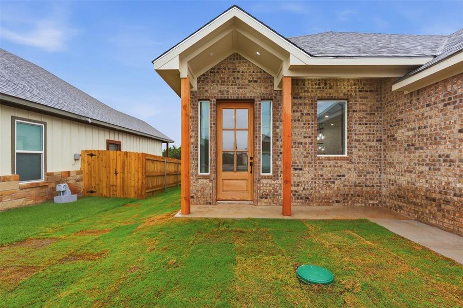 Brick exterior with wood-clad entry door and vertical sidelight Brick exterior with wood-clad entry door and vertical sidelight