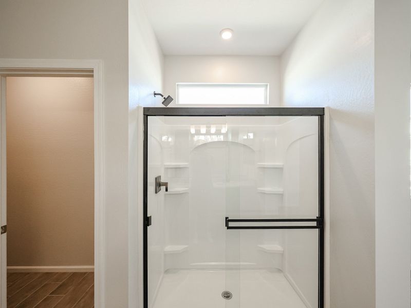 A bathroom with a glass shower. A bathroom with a glass shower.