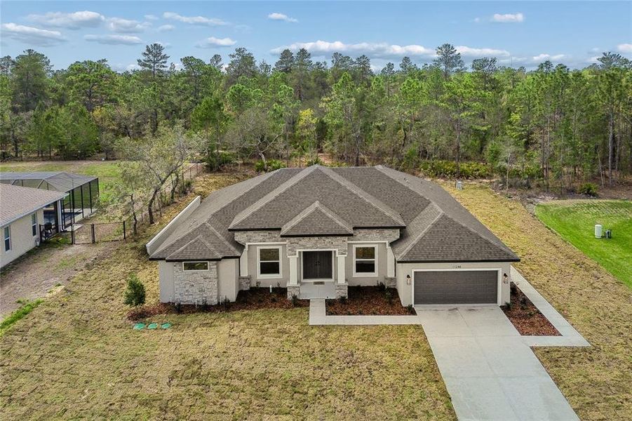 Front exterior of a new home in , Weeki Wachee, FL, highlighting curb appeal (Image 27). Front exterior of a new home in , Weeki Wachee, FL, highlighting curb appeal (Image 27).