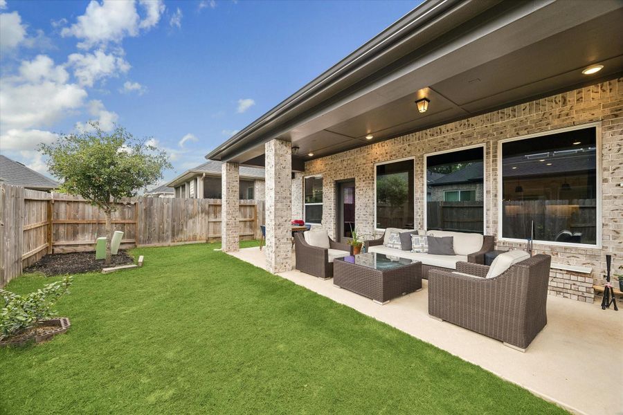 The covered outdoor living area creates the perfect extension of the home with multiple seating areas, ceiling fans, and plenty of room for outdoor entertaining. The covered outdoor living area creates the perfect extension of the home with multiple seating areas, ceiling fans, and plenty of room for outdoor entertaining.