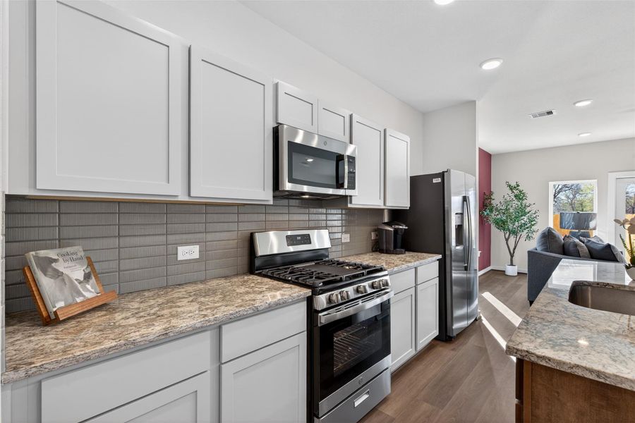 Well-equipped kitchen featuring stainless steel appliances, modern cabinetry, and a stylish tile backsplash. Well-equipped kitchen featuring stainless steel appliances, modern cabinetry, and a stylish tile backsplash.