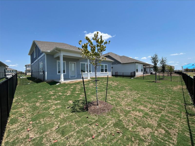 Back of house featuring a patio area, a fenced backyard, and a shingled roof