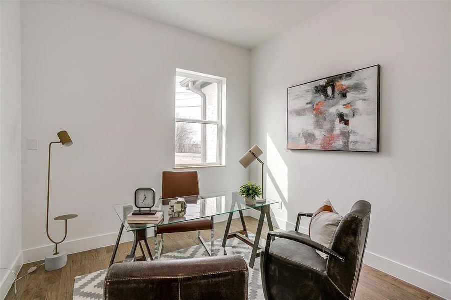 Home office with wood finished floors and baseboards